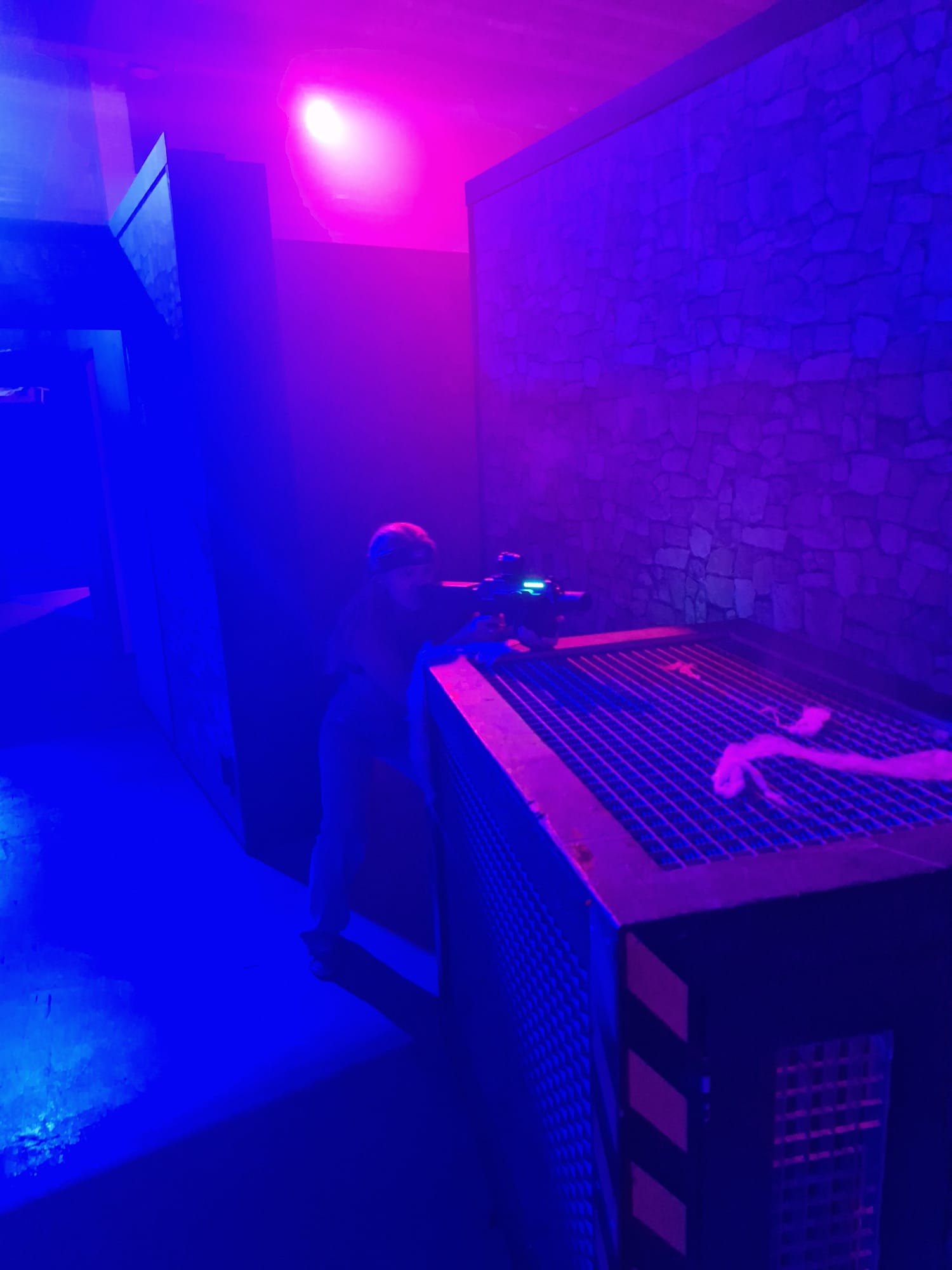 A participant in action during Halloween laser tag at Unit 13