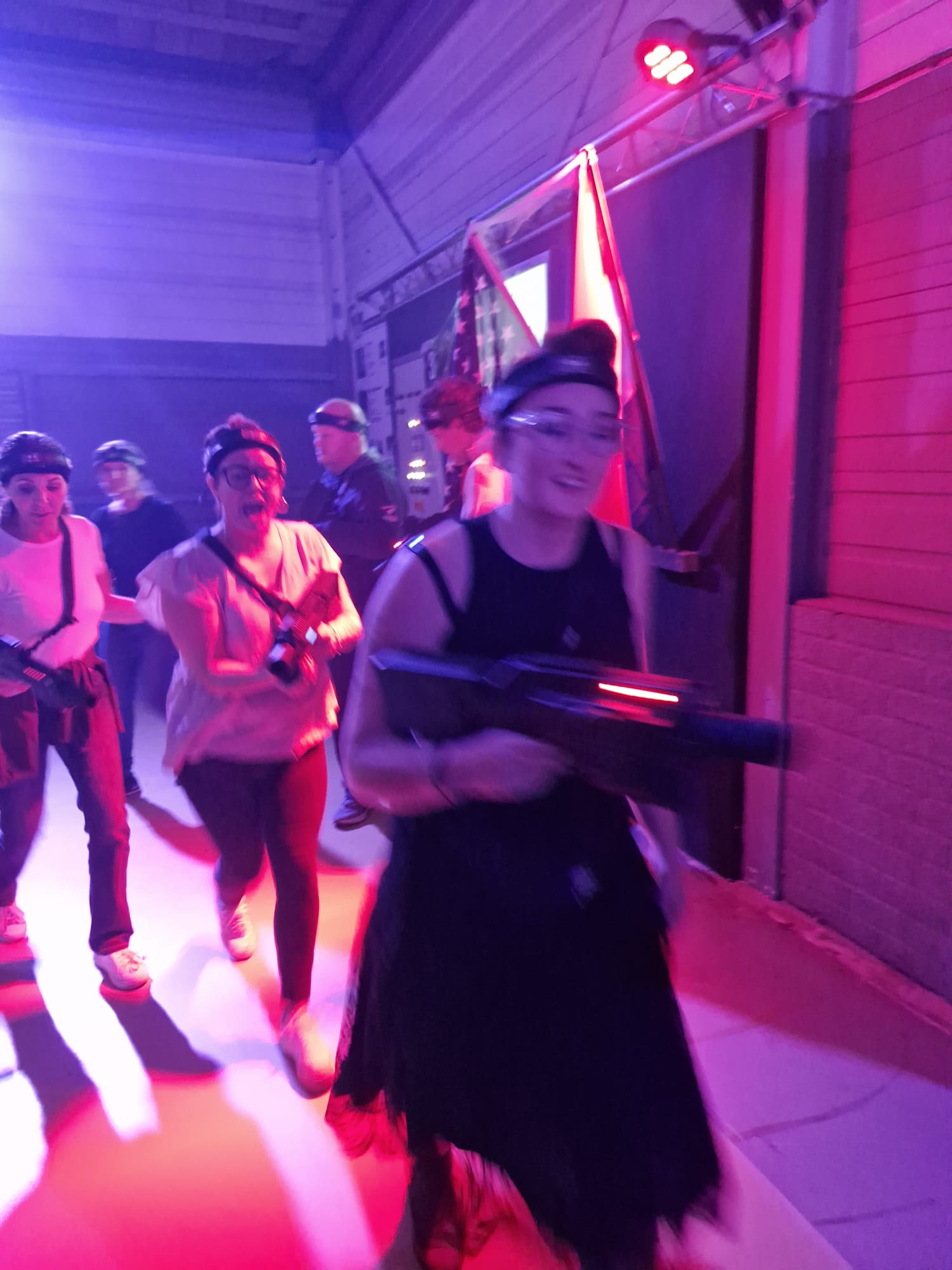 Participants in costume playing Halloween laser tag at Unit 13