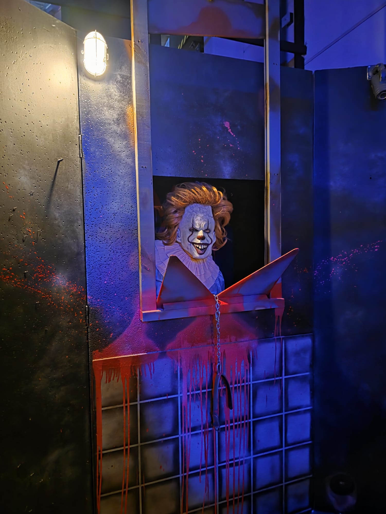 A clown monster actor in a cage