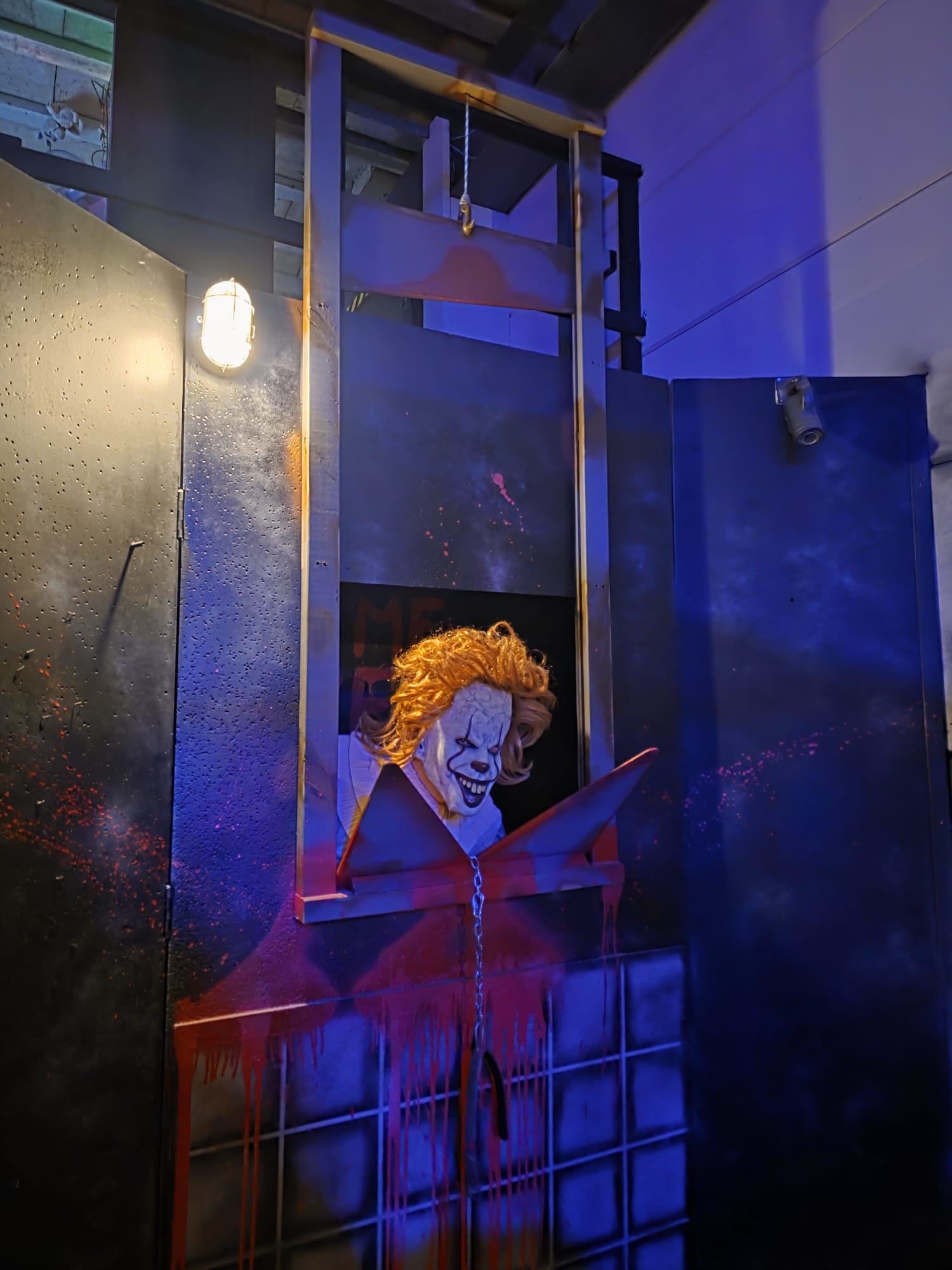 A clown actor inside the blue laser tag arena